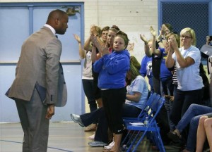 Third grade teacher Omar Currie acknowledges applause in response to his impassioned speech at a community hearing. Photo: Harry Lynch, hlynch@newsobserver.com
