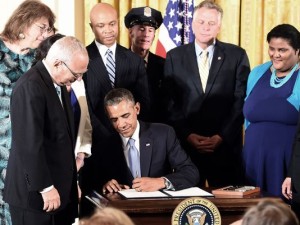 President Obama signing the executive order protecting LGBT Americans working at the Federal Government level.  (photo by Jewel Samad, AFP / Getty Images)