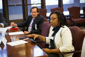 Blog author Stan Kimer (background) listens as Rev Sekinah Hamlin (foreground), another NC Council of Churches former President and now with the Ecumenical Poverty Initiative, shares some points.