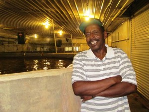 Entrepreneur and Taylor Fish Farm co-founder Valee Taylor standing in front of one of his large tilapia pools